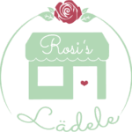 Logo: Ein Häuschen mit einem Kreis, einer Rose. Mit der Aufschrift Rosis Lädele
